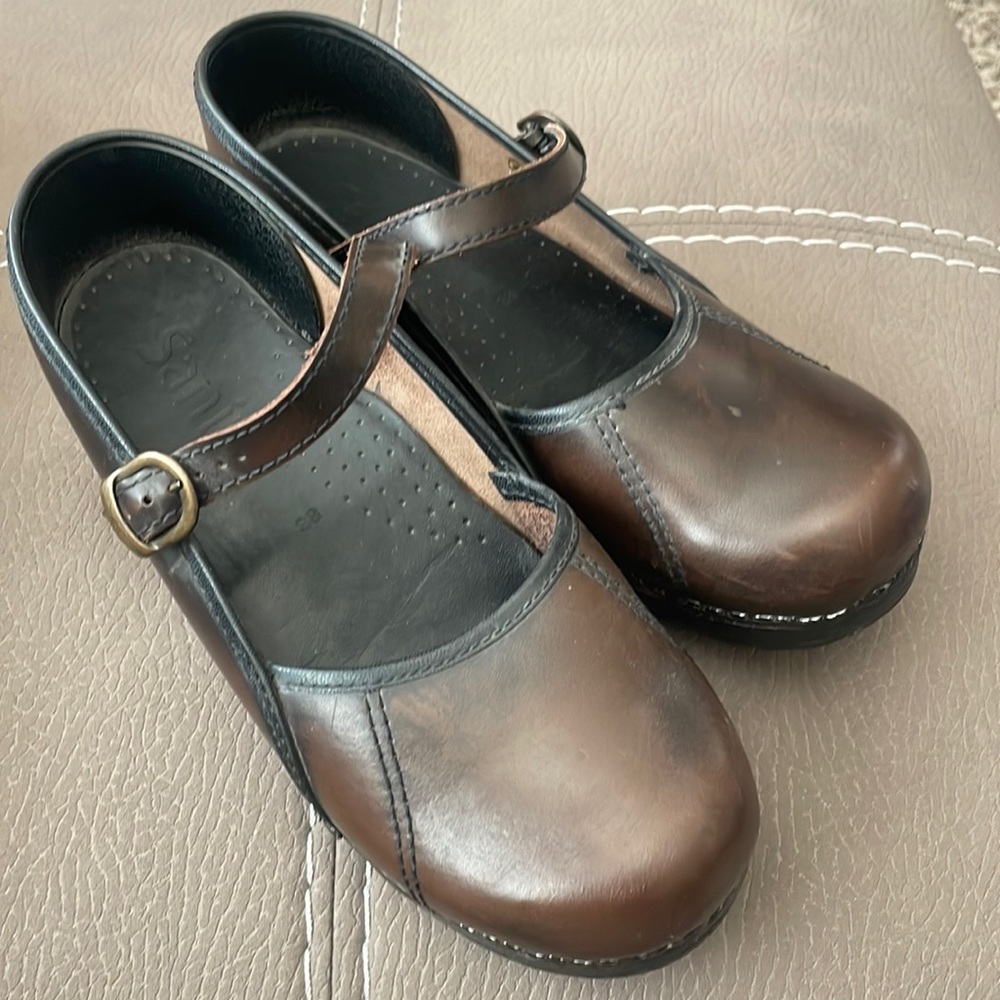 Brown clogs.
